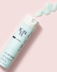 Top view of Yon-Ka Paris Lait Nettoyant (200 ml) with product smear to show pale blue color and texture of product