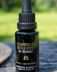Lifestyle shot of de Mamiel Summer Facial Oil (20 ml) on table top outside