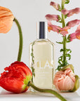 Lifestyle shot of Laboratory Perfumes Atlas Eau de Toilette with poppies and flowers in the foreground and background