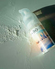 R+Co Skyline Dry Shampoo Powder - dry shampoo on table next to bottle
