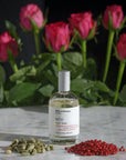 Miller et Bertaux Shanti Eau de Parfum (100 ml) lifestyle shot with red roses and ingredients in the background