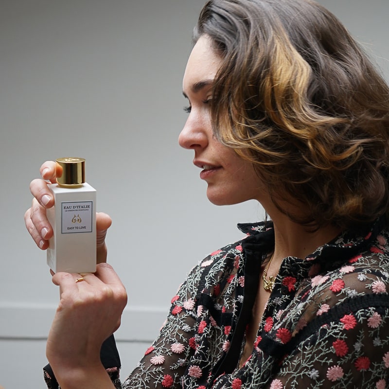 Close up of model holding Eau d&#39;Italie Easy to Love Eau de Parfum Spray bottle (100 ml)