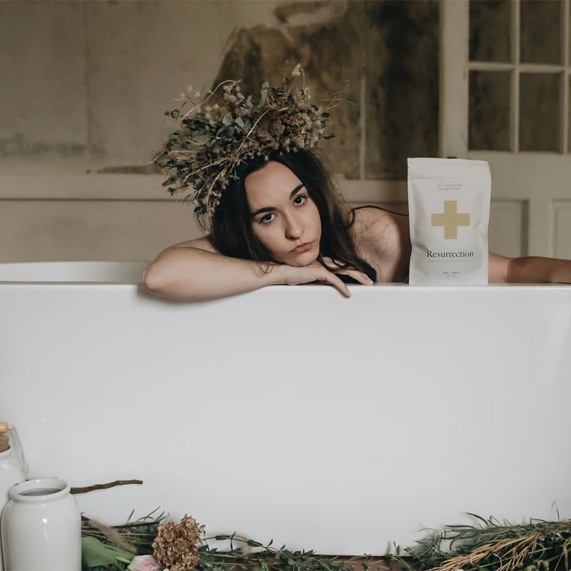 Pursoma Resurrection - Model shown in bathtub with flowers and bag