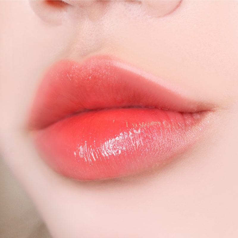 Paul + Joe Liquid Rouge Shine (0.28 oz, Quelle Joie (08)) on model&#39;s lips