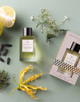 Essential Parfums Nice Bergamote Perfume by Antoine Maisondieu with note ingredients scattered - beauty shot