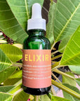Neil Naturopathic Elixir Oil Pre-Wash Treatment - Elixir bottle shown on top of plant