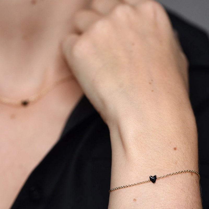 Close up of model&#39;s wrist wearing Titlee Paris Grant Heart Bracelet – Black