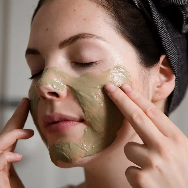 Floragy Refresh – Matcha + Mint Clay Mask - Closeup of model applying product to face 