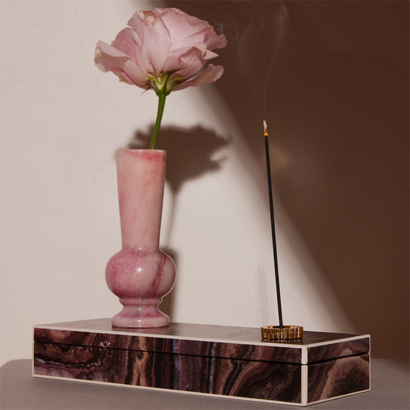 Oribe Valley of Flowers Incense - Product displayed next to flower and vase