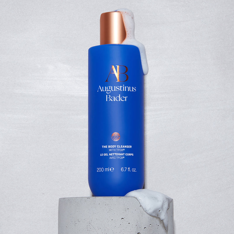 Augustinus Bader The Body Cleanser - Product displayed on stone