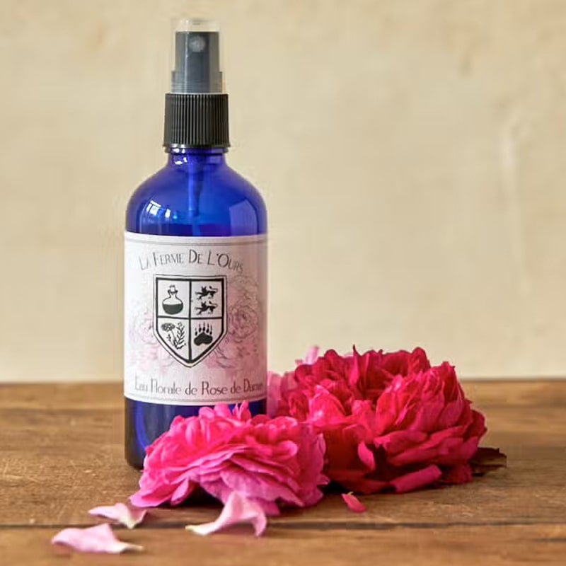 La Ferme de l&#39;Ours Damask Rose Flower Water - Beauty shot, product shown on wood table with rose petals