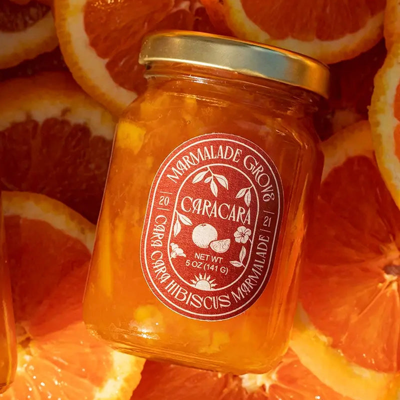 Marmalade Grove Cara Cara &amp; Hibiscus Marmalade - Overhead shot of product on top of orange slices