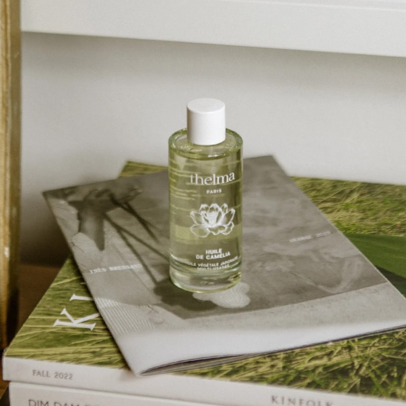 Thelma Paris Camelia Seed Oil- Product shown on top of books