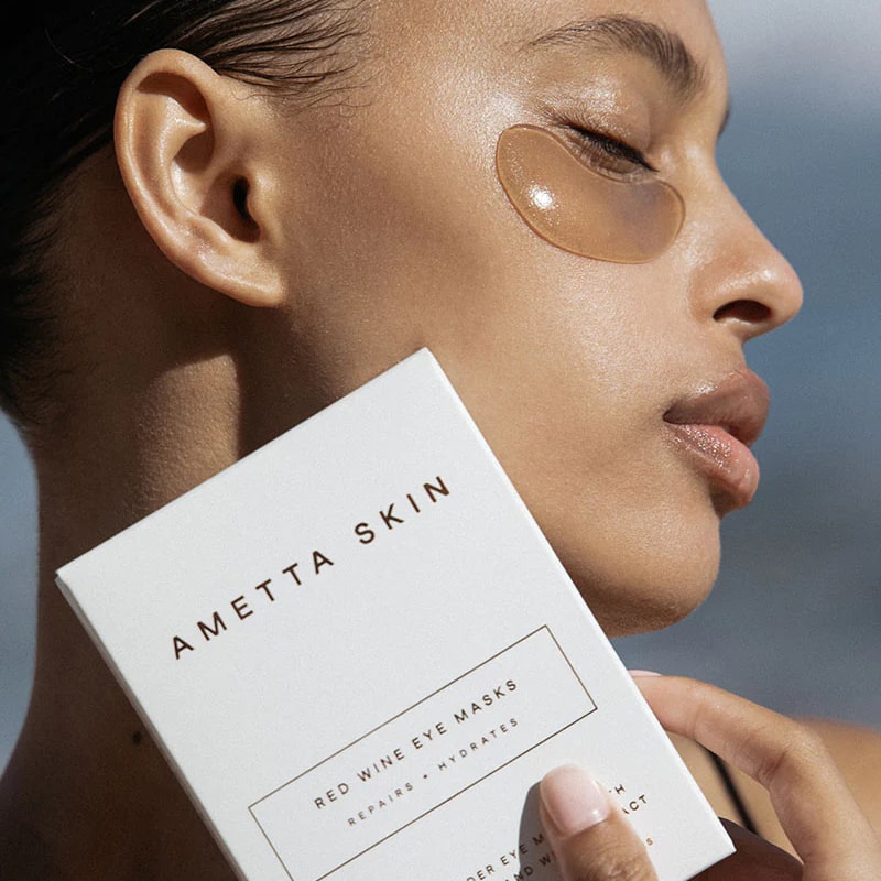 Ametta Skin Care Red Wine Eye Masks- Model shown holding box next to face