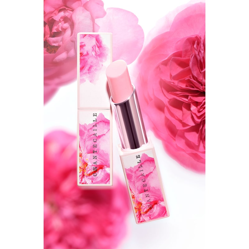 Chantecaille Rose de Mai Radiant Lip Balm - product shown with cap off next to product with cap on with roses