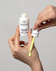 Odacite Edelweiss Extreme™ Derm-Restore Super Serum - model shown holding bottle and using dropper on hands