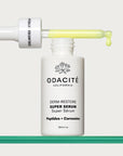 Odacite Edelweiss Extreme™ Derm-Restore Super Serum - product shown with dropper sideways on top of bottle on glass table