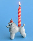 Camp Hollow Poodle Cake Topper - side view of cake topper with lit candle