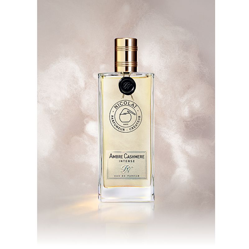 Parfums de Nicolai Ambre Cashmere Intense Eau de Parfum 100 ml with pastel clouds behind it