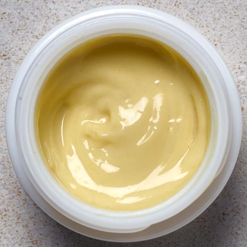 Ursa Major Golden Hour Recovery Cream shown top view open on stone surface