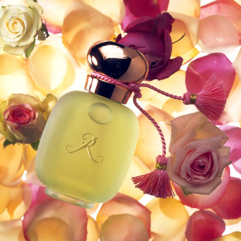 Up Close &amp; Personal with Les Parfums de Rosine Paris showing a bottle of perfume with roses in background