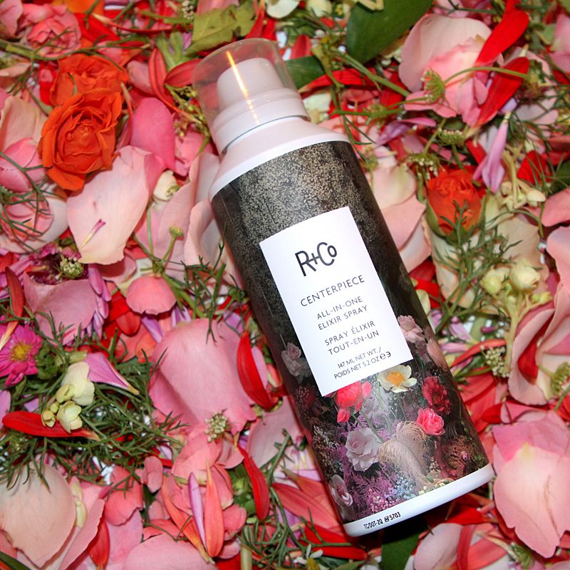 R+Co Centerpiece All-In-One Elixir Spray laying on flowers