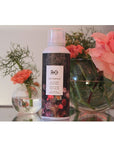 R+Co Centerpiece All-In-One Elixir Spray next to flowers