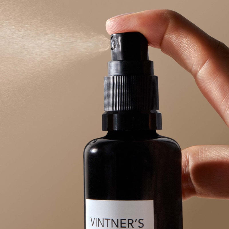 Lifestyle shot of Vintner&#39;s Daughter Active Treatment Essence showing spray dispensed from bottle