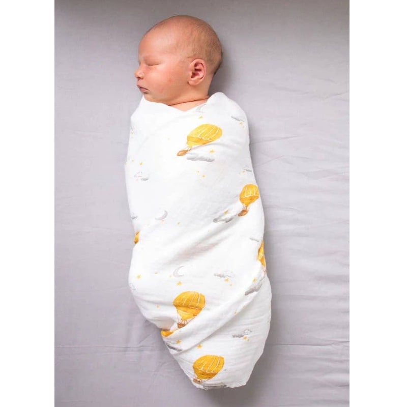 Malabar Baby Organic Cotton Muslin Swaddle – Hot Air Balloon shown wrapped around baby (not included)