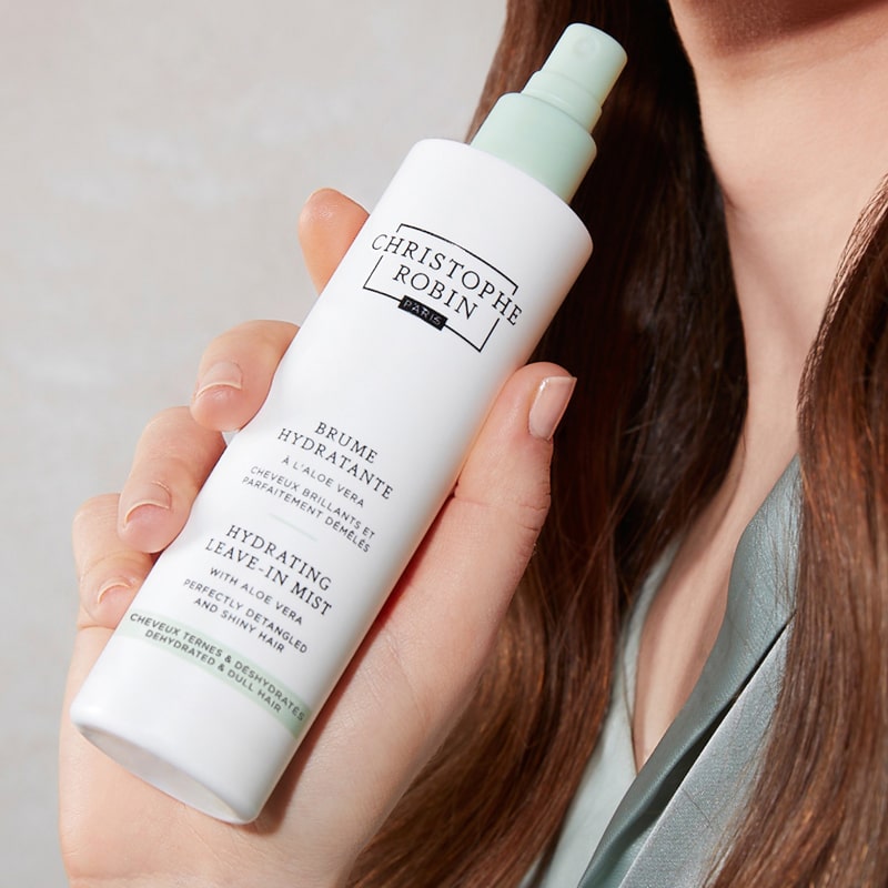 Christophe Robin Hydrating Mist with Aloe Vera shown in model&#39;s hand