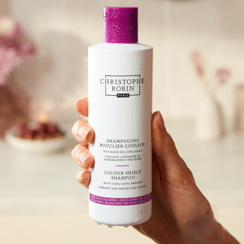Christophe Robin Color Shield Shampoo in model's hand