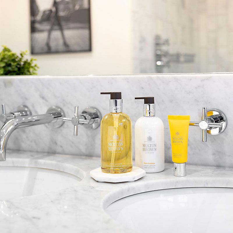 Molton Brown Flora Luminare Hand Lotion - Lifestyle Shot on sink with Hand Wash