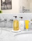 Molton Brown Flora Luminare Hand Lotion - Lifestyle Shot on sink with Hand Wash