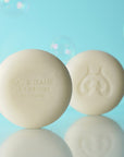 Eau d'Italie Scented Soap round soap shown unwrapped (front and back of soap) with the Eau d'Italie logo