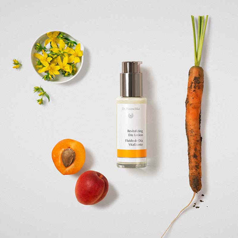 Dr. Hauschka Revitalizing Day Lotion - beauty shot with ingredients (Carrot, Peach, Flowers)