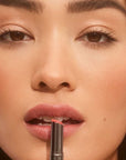 Roen Beauty Elixir Tinted Lip Oil Balm – Stella showing model putting balm on