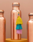 Tamra Copper LA Tamra Tassels: Orchid Trio showing hanging from copper bottle