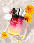 Juliette Has A Gun Magnolia Bliss Eau de Parfum shwoing sitting in water and sand with flowers 