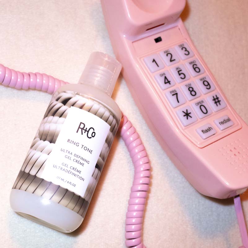 R+Co Ring Tone Curl Cream showing product with phone cord  and pink phone