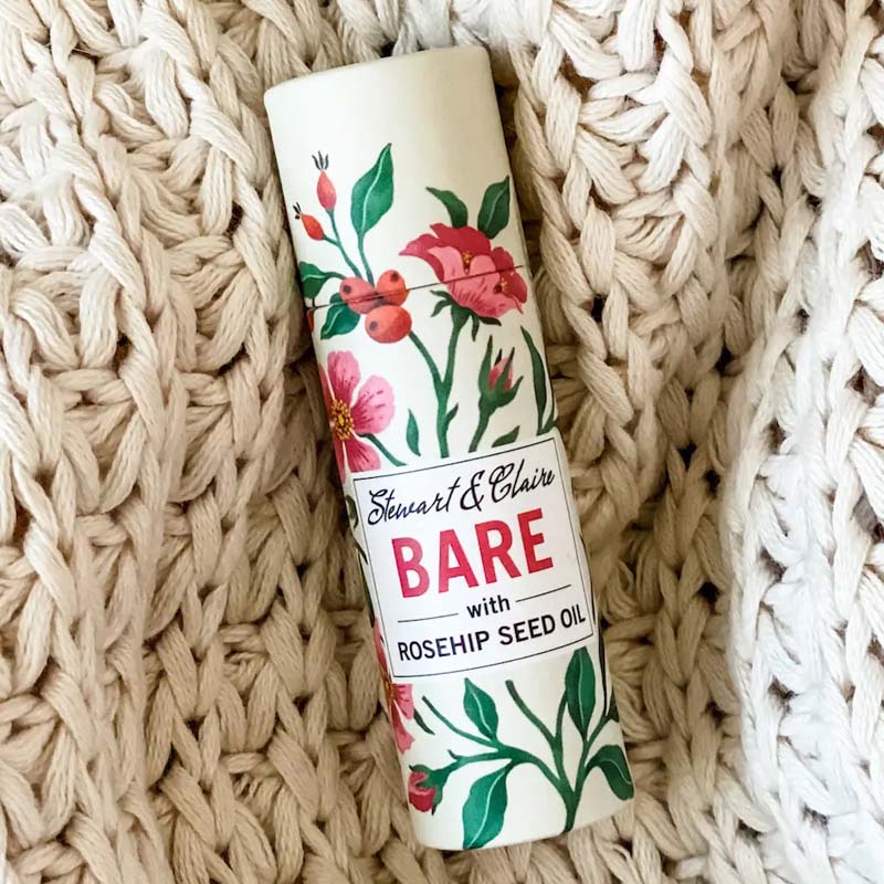 Stewart &amp; Claire Bare Unscented Lip Balm with Rosehip Seed Oil showing on a knitted blanet