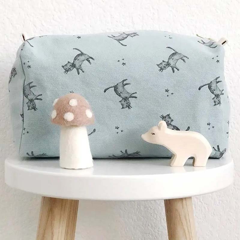 Rose in April Cat Toiletry Bag – Cloud Blue showing on stool with toys