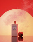 Eau d'Italie Mystic Sunset Eua de Parfum Spray showing with lid sitting next to bottle in front of a mystic sunset