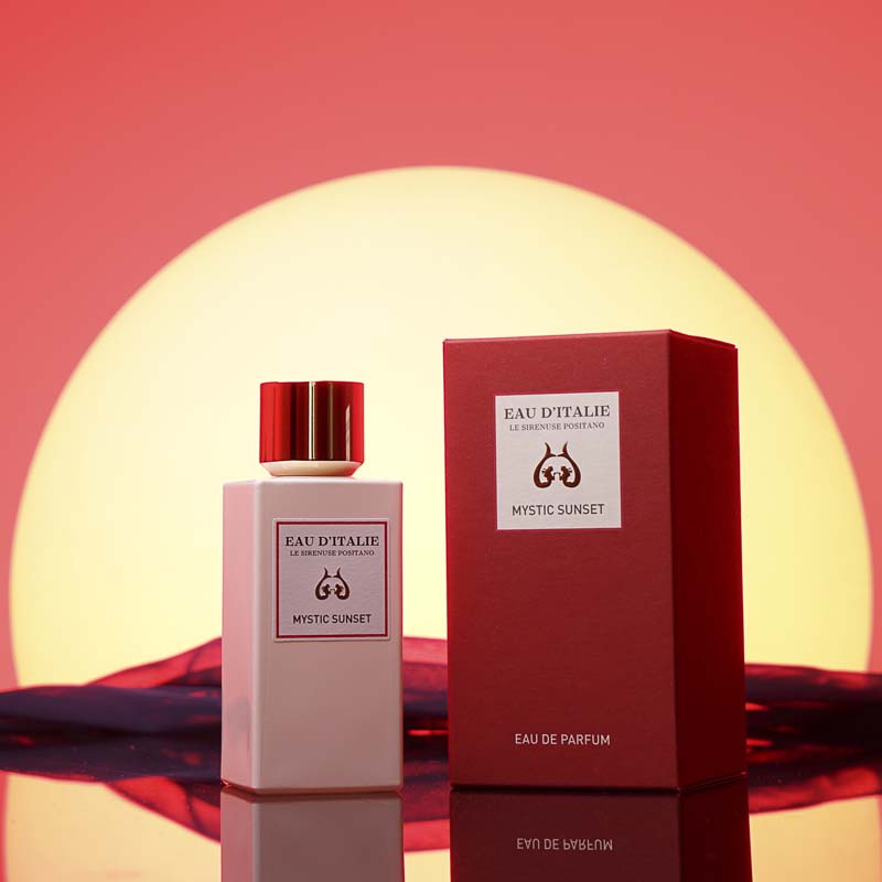 Eau d'Italie Mystic Sunset Eua de Parfum Spray showing bottle next to packaging in front of a sunset
