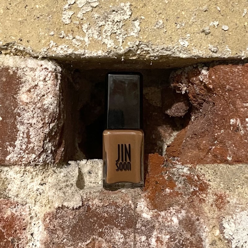 JINsoon Nail Lacquer – Earth Clay - Product shown on bricks