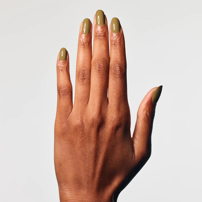 Model with dark skin tone wearing JINsoon Nail Lacquer – Green Clay