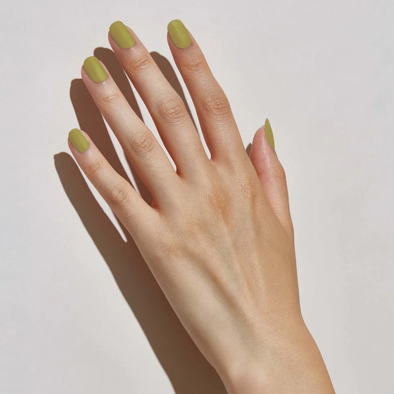 Model with light skin tone wearing JINsoon Nail Lacquer – Green Clay