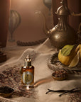 Penhaligon's Legacy of Petra Eau De Parfum - Beauty shot product shown on blanket next to lemons and herbs and spices. 