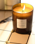 Essential Parfums Bois Imperial Scented Candle - Product shown lit on table