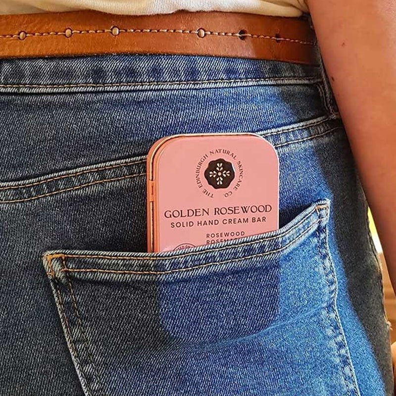 The Edinburgh Natural Skincare Company Golden Rosewood Solid Hand Cream Bars - Product shown in models pocket
