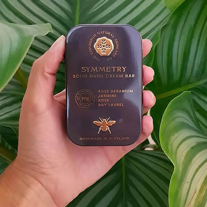 The Edinburgh Natural Skincare Company Symmetry Solid Hand Cream Bar - Product shown in models hand